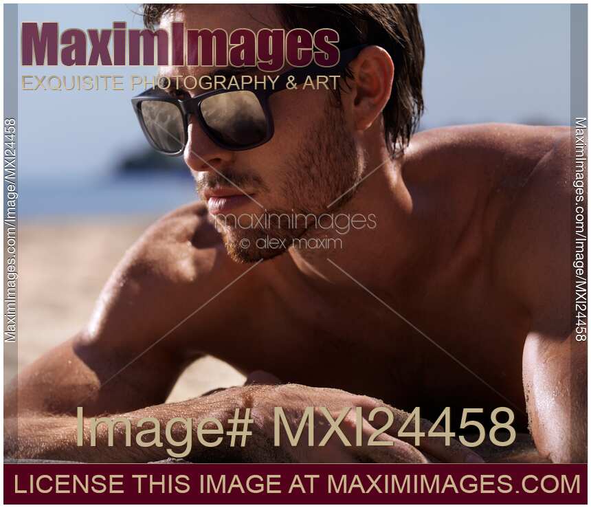 Closeup portrait of a man in sunglasses at the beach