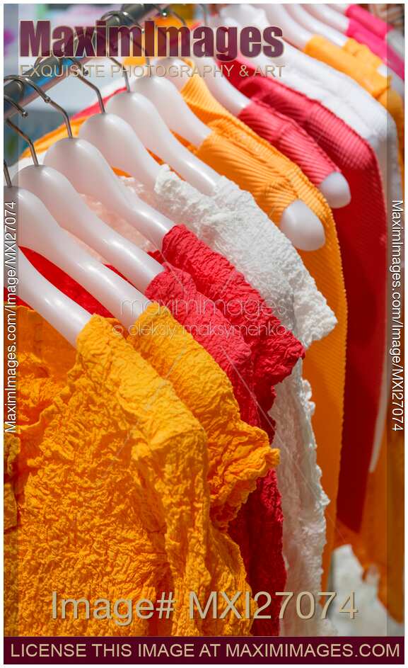 Colorful clothes on hangers