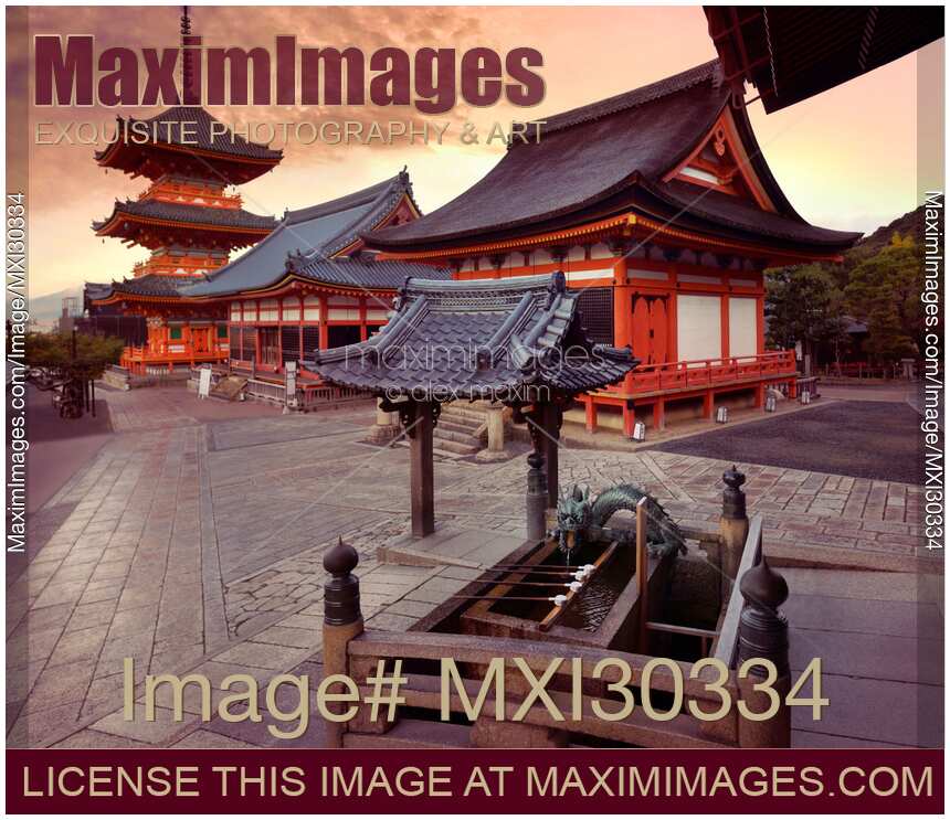 Colorful sunrise scenery of Kiyomizu-dera Buddhist temple buildings and Chozubachi water ablution pavilion basin Kyoto Japan
