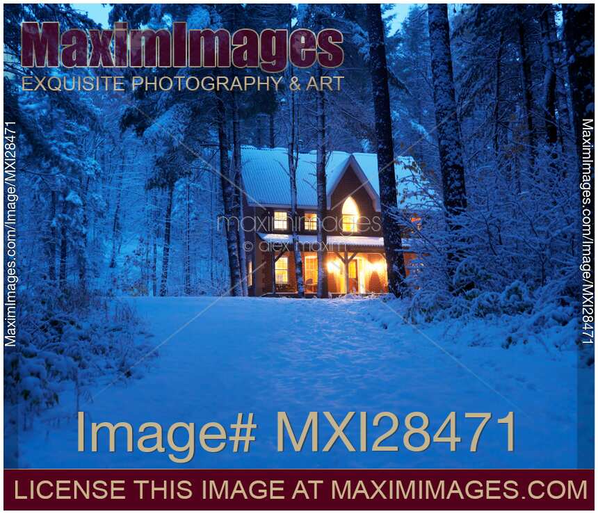 Country house with lights on snowy winter evening Ontario Canada