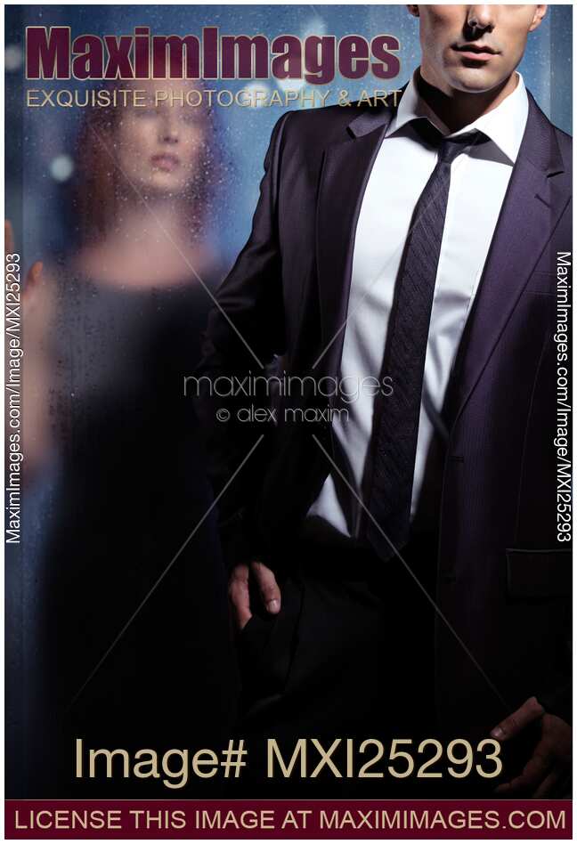 Couple dramatic portrait man leaving woman behind glass