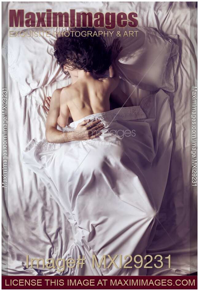 Couple kissing in bed in the morning