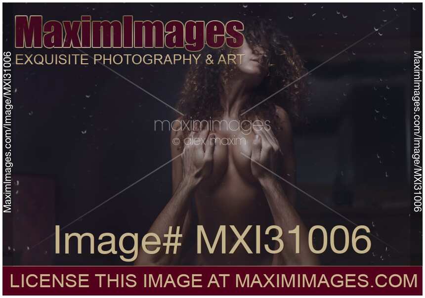 Couple making love behind a wet window with rain drops on it art nude sensual portrait