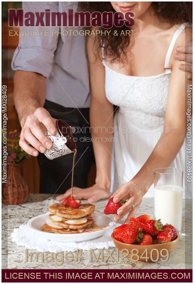 Couple preparing pancakes together in the kitchen