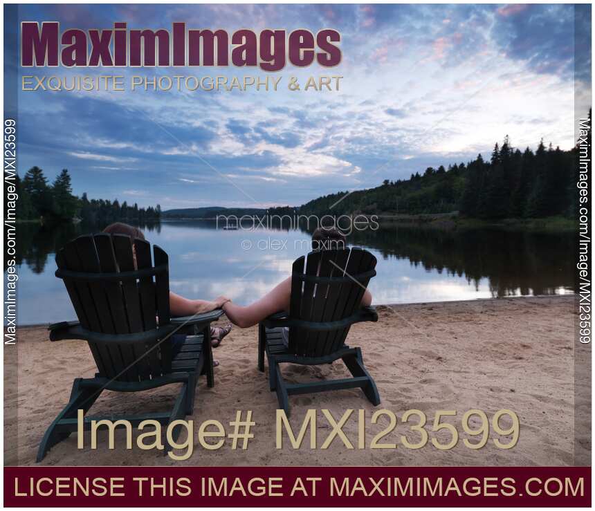 Couple Sitting in Chairs at the Lake