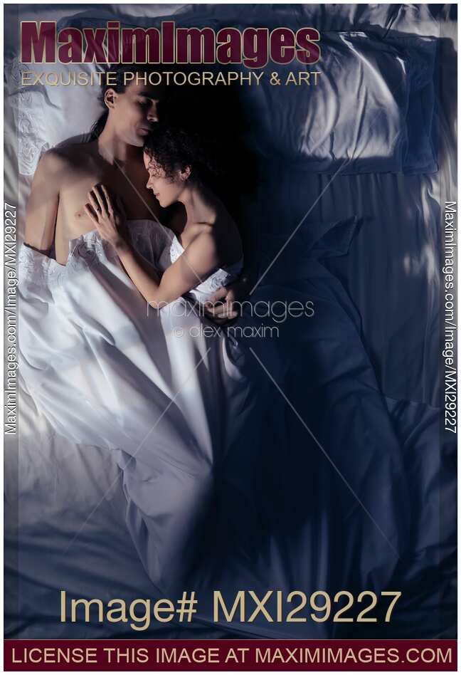 Couple sleeping together in bed at night