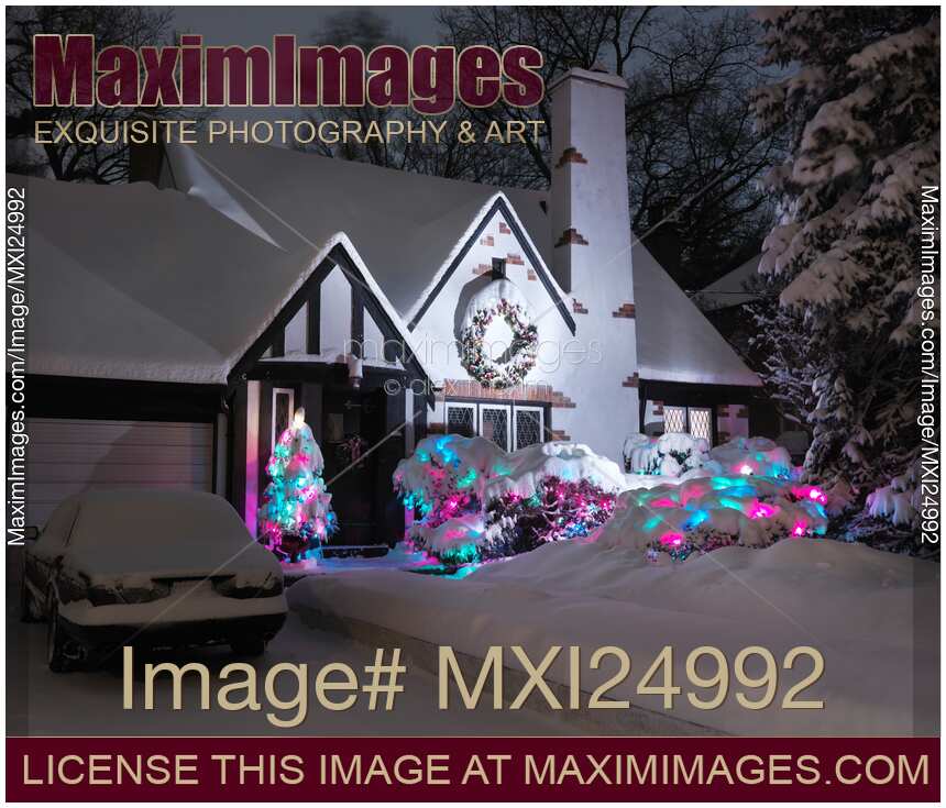 Covered with snow house with Christmas lights