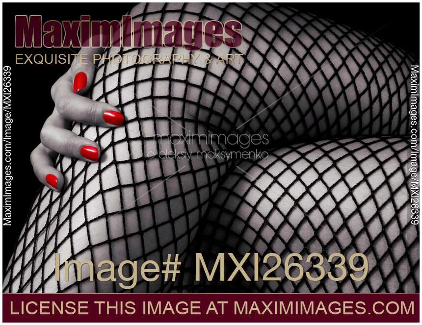 Crossed sexy woman legs in fishnet stockings