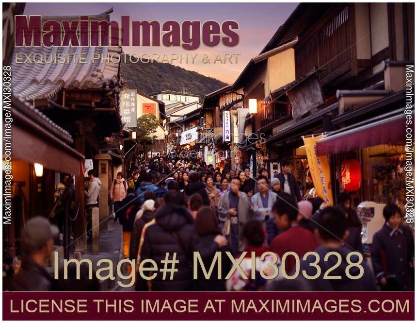 Crowded with people Matsubara dori street during sunset in Kyoto Japan