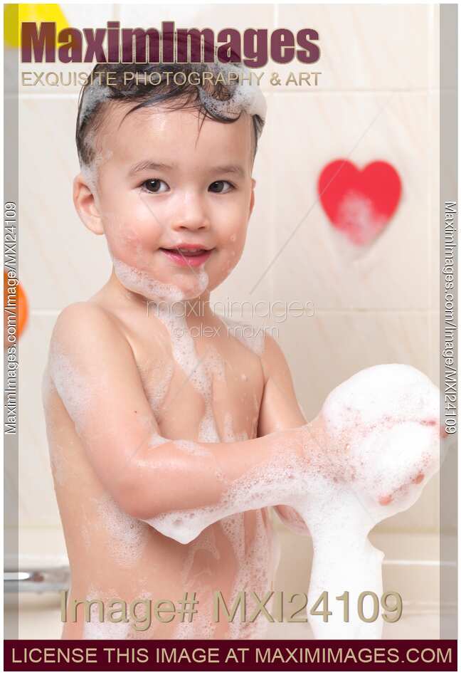 Cute baby boy playing in a foam bath