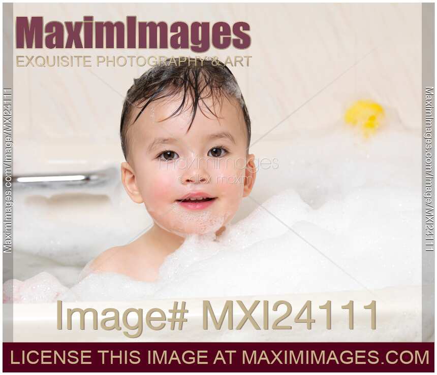 Cute little child enjoying a foam bath