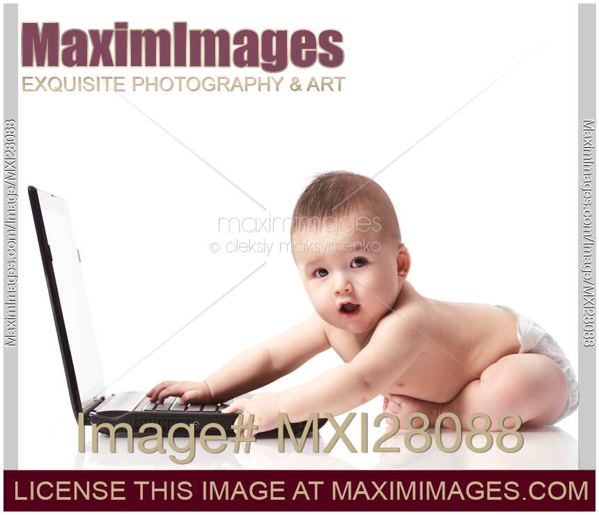 Cute surprized baby in diaper playing with computer