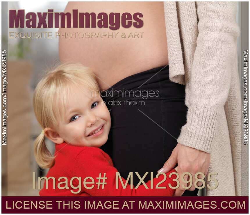 Daughter Hugging Her Pregnant Mother