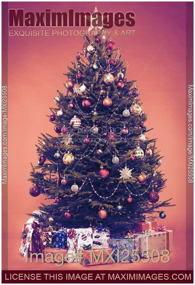 Decorated vintage Christmas tree with presents under it