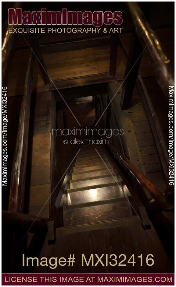 Descending dark wooden staircase in a floor opening of a house Cellar Dungeon Basement