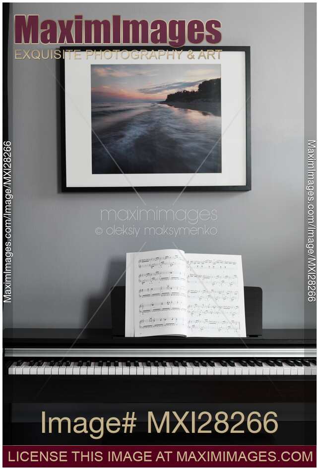 Digital piano with music scores in a room