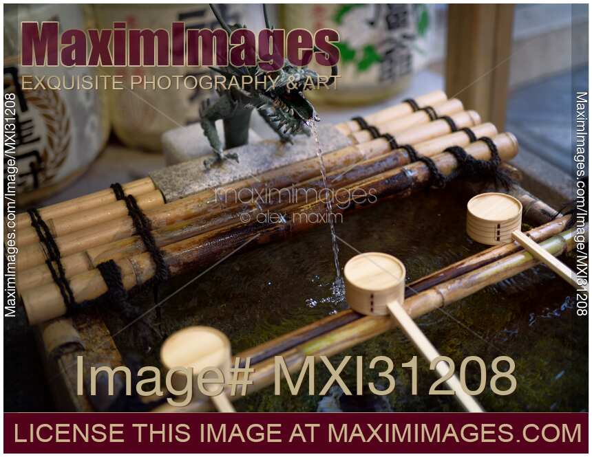 Dragon head Chozuya water purifying basin with bamboo dippers at a temple in Kyoto