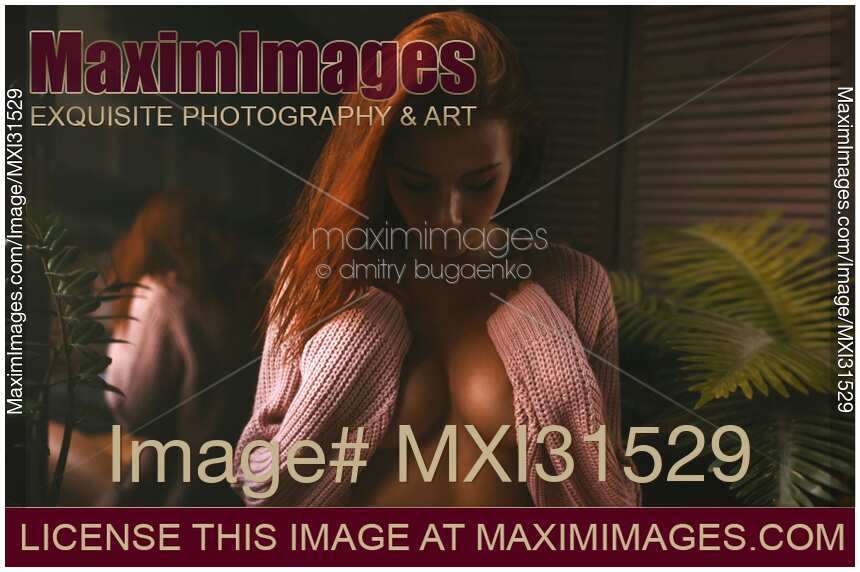 Dramatic expressive portrait of a woman covering bared chest with her arms