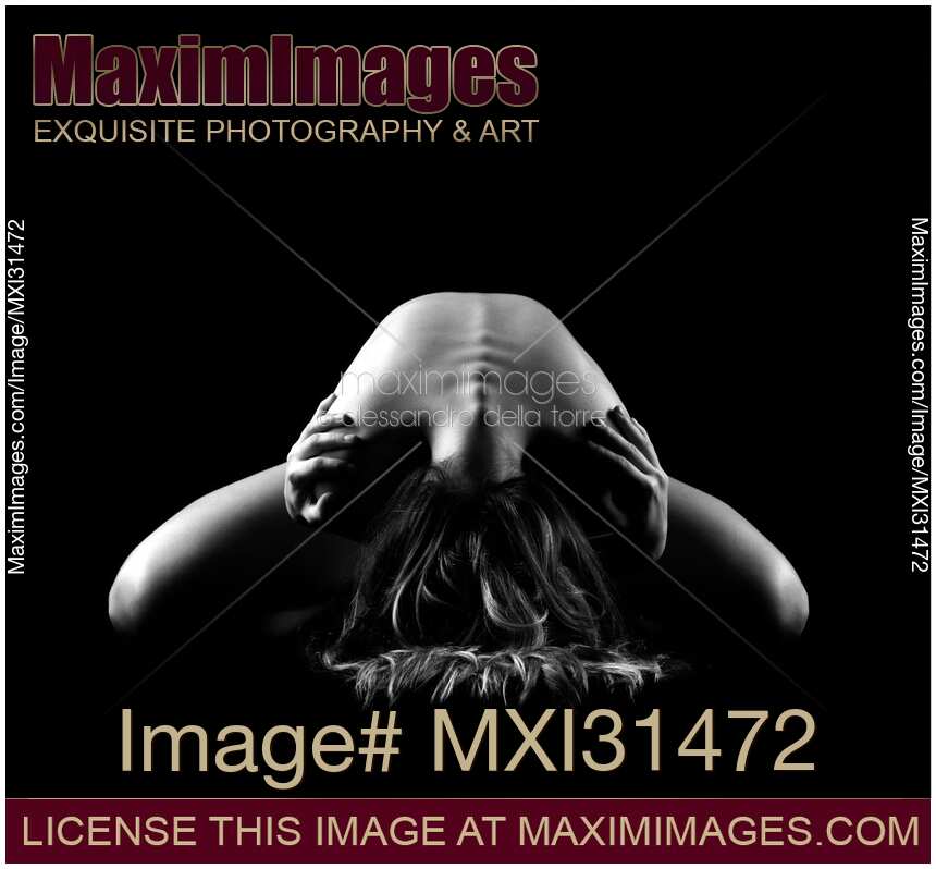 Dramatic nude figure of a woman leaning forward arching her back