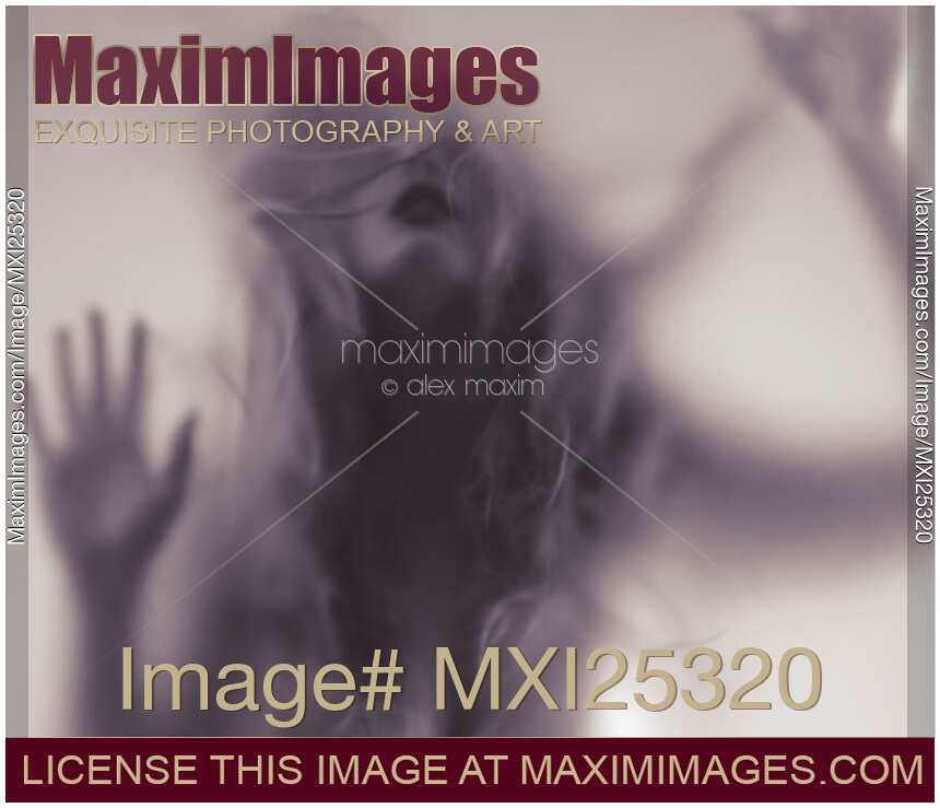 Dramatic photo of woman blurred silhouette behind hazy glass