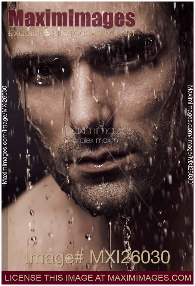 Dramatic portrait of man face with water pouring over it