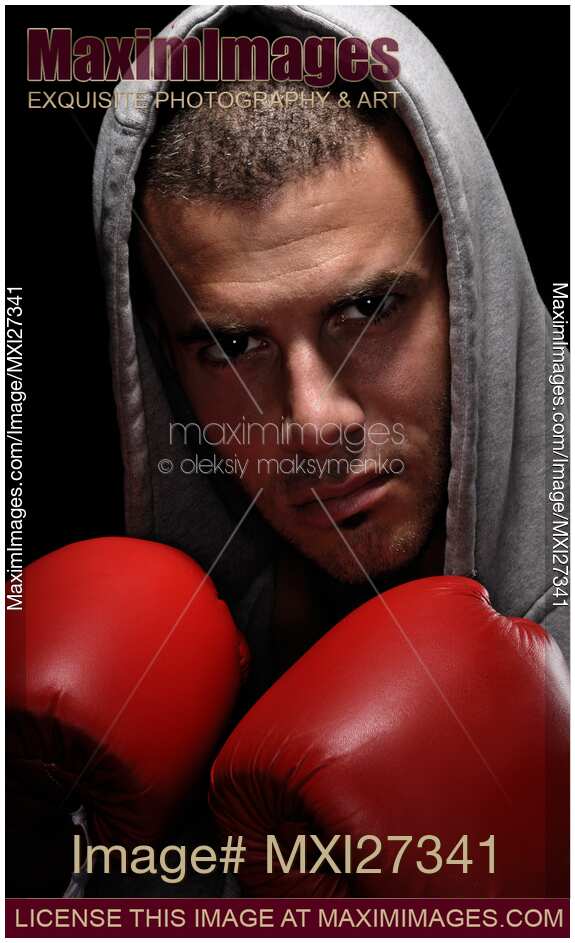 Dramatic portrait of man wearing boxing gloves