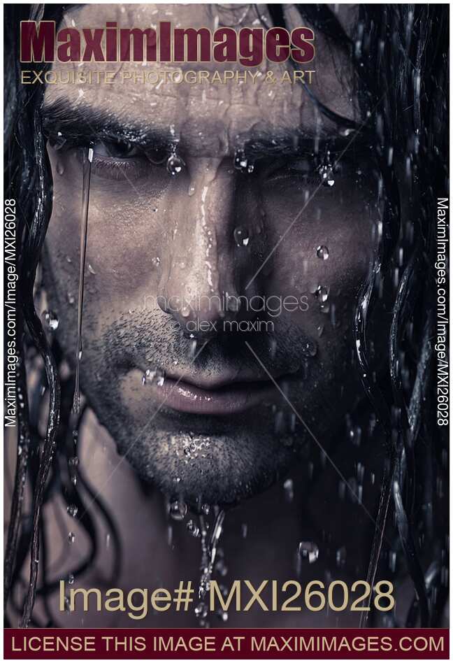 Dramatic portrait of man wet face with long hair