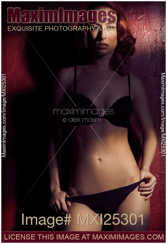 Dramatic portrait of sexy red haired woman wearing lingerie
