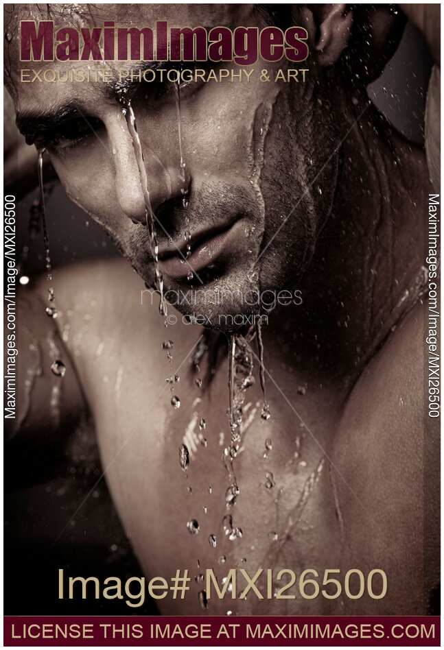Dramatic portrait of young man under a shower