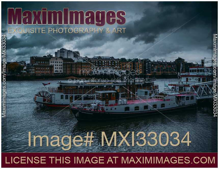 Dramatic scenery of cruise boats and restaurants on river Thames in London