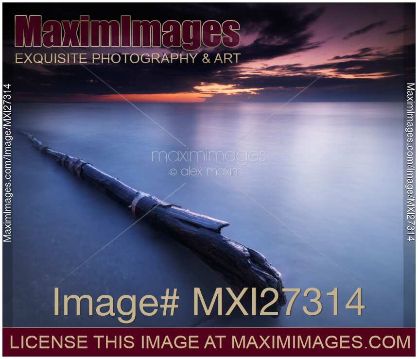 Driftwood in dramatic sunset scenery at lake Huron Grand Bend