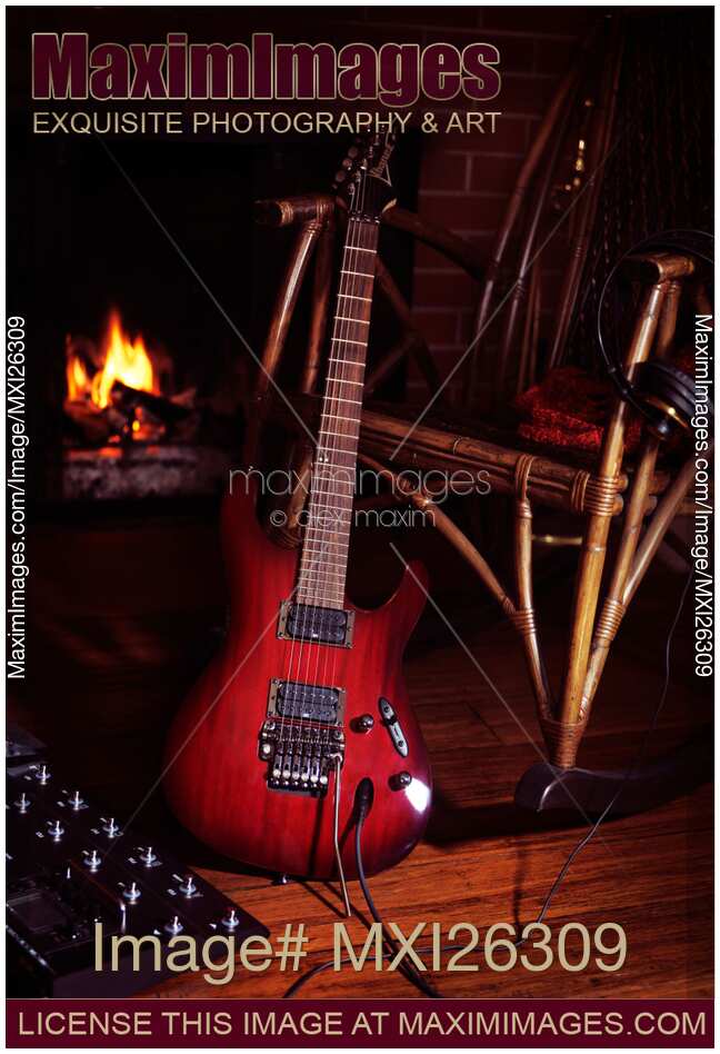 Electric guitar propped on chair near fireplace