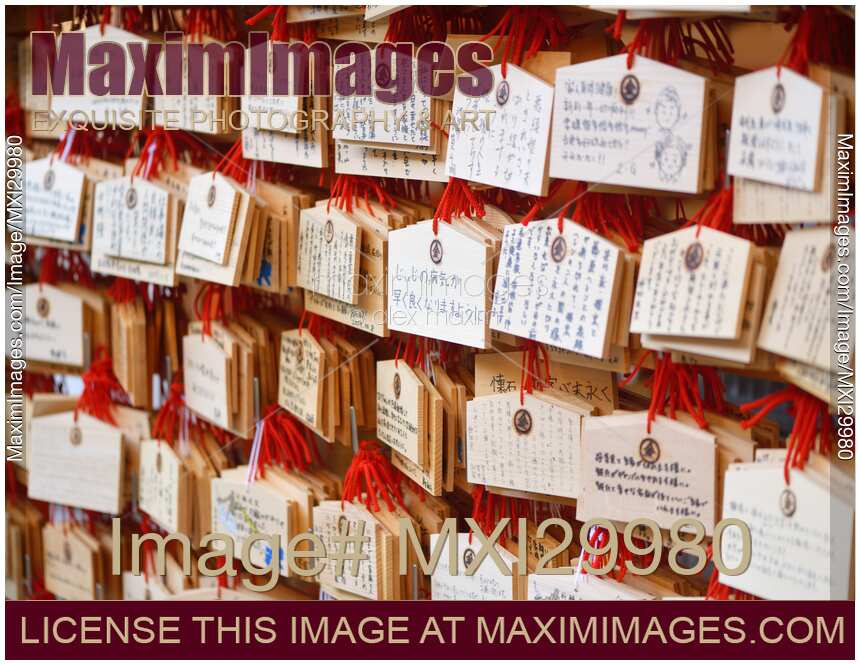 Ema wooden plaques with prayers and wishes hanging at Shinto shrine in Japan
