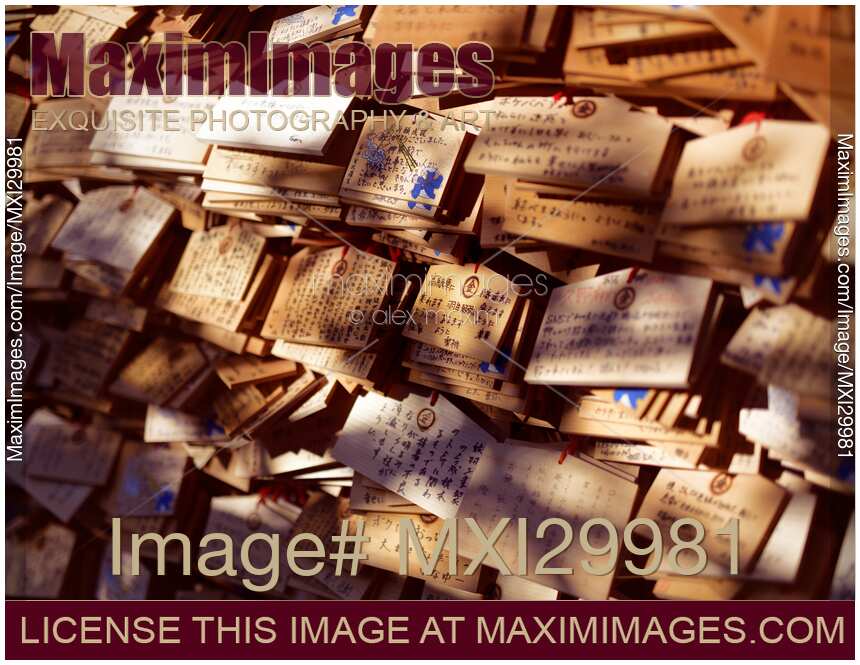 Ema wooden votive plates with written prayers and wishes at Shinto shrine in Japan