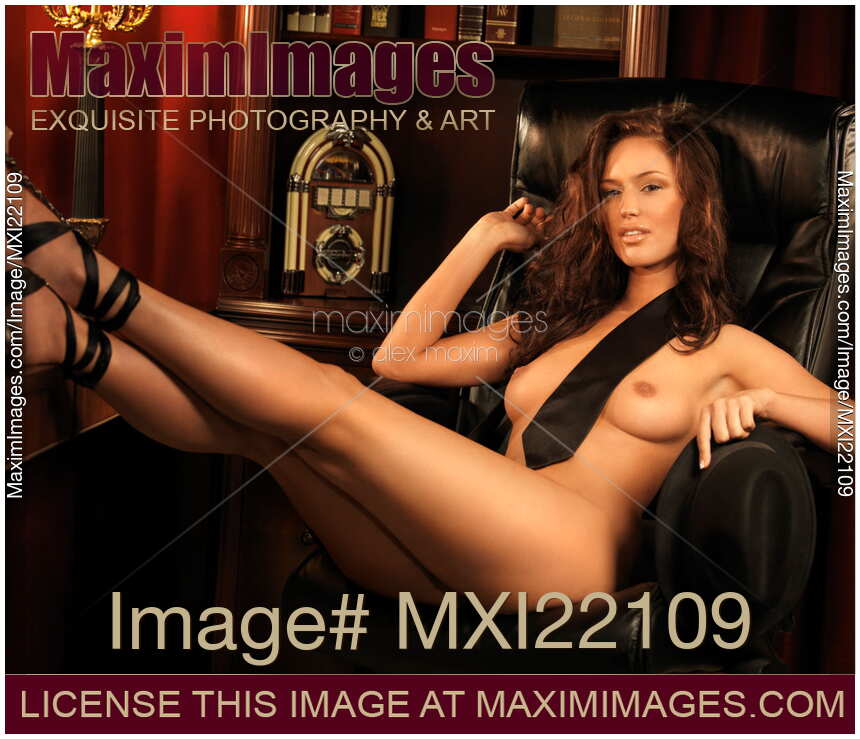 Erotic boudoir portrait of a sexy woman in office chair wearing only black neck tie