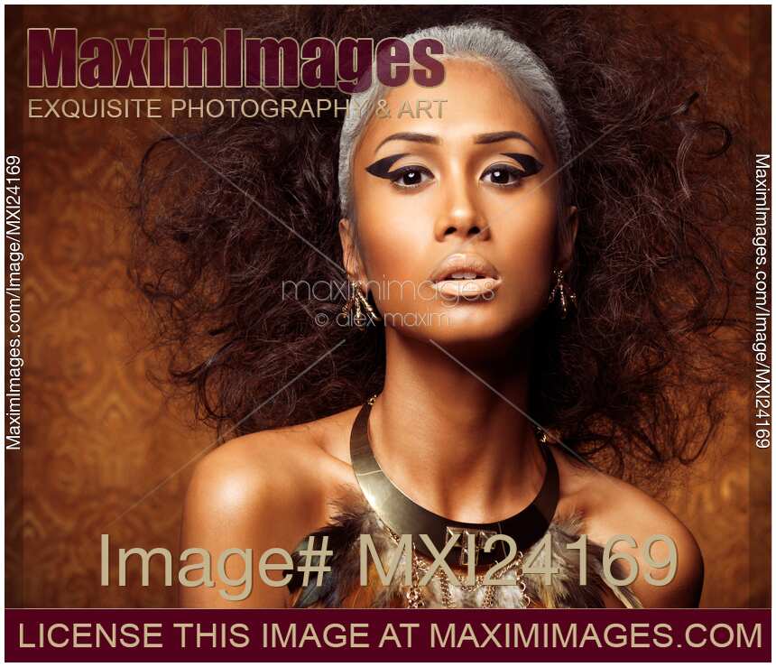 Exotic beauty portrait of a woman wearing feather necklace