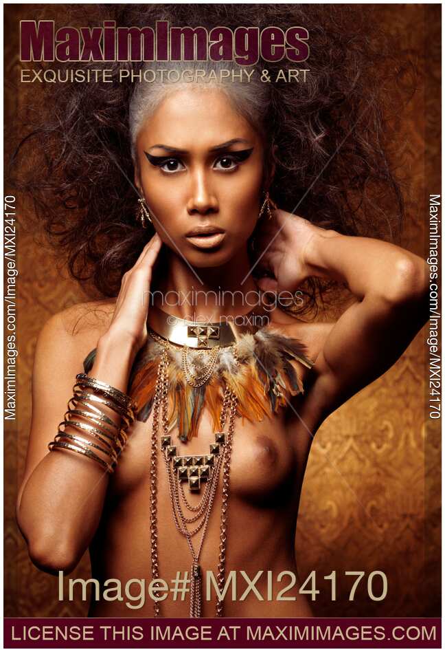 Exotic beauty portrait of a woman wearing feathers and accessories