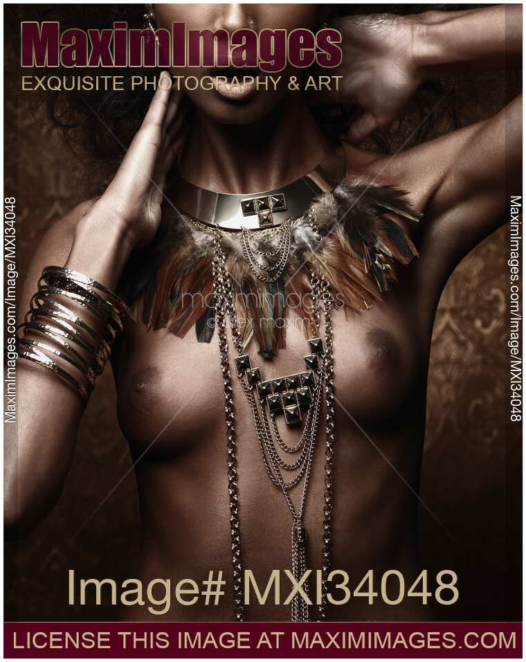 Exotic nude aboriginal woman with tribal feather necklace and jewelry on her bare chest