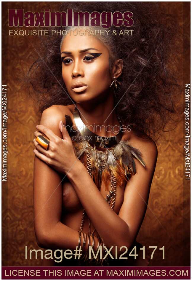 Exotic portrait of a beautiful woman with bird themed styling