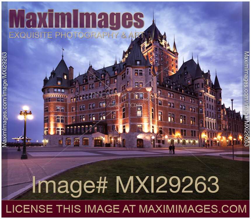 Fairmont Le Château Frontenac lit by street lights at dusk in Old Quebec City