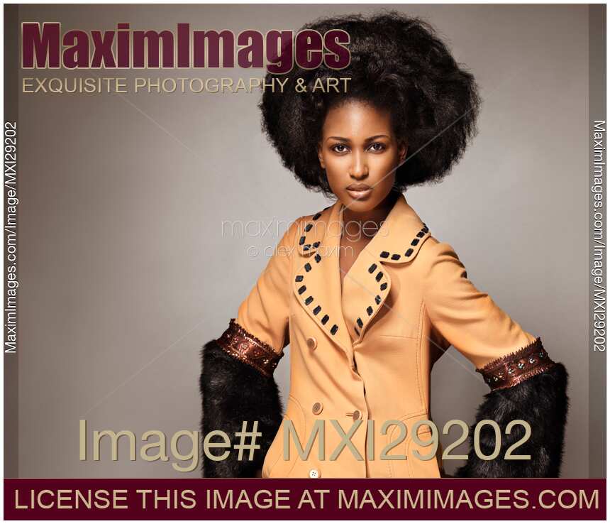 Fashion beauty portrait of a black african model wearing a coat with fur