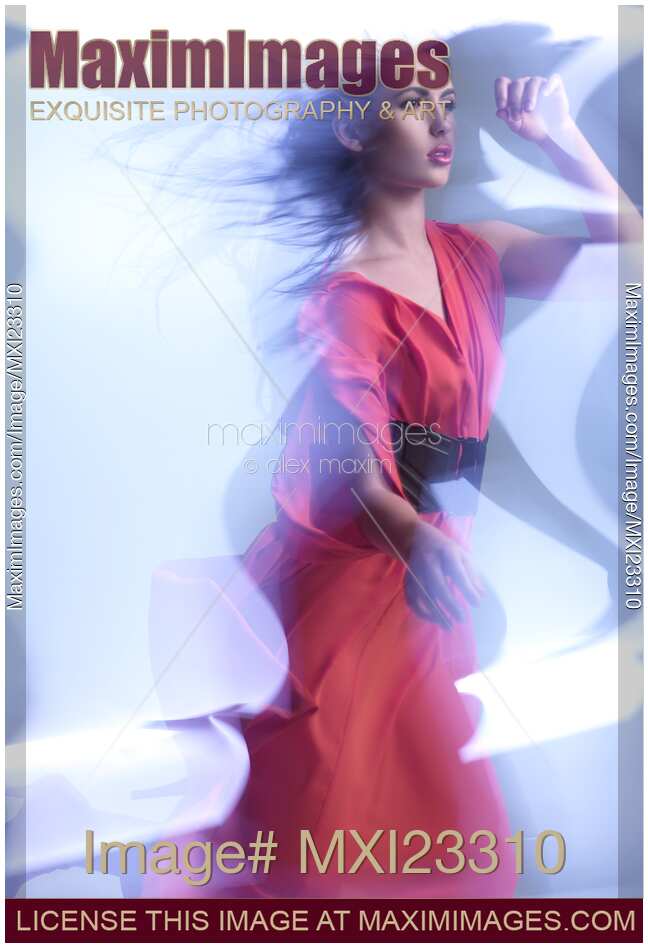 Fashion Photo of a Woman in Shining Blue Light Wearing a Red Dress
