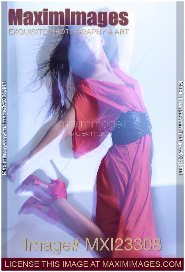 Fashion Photo of Woman in Red Dress Jumping in Blue Light