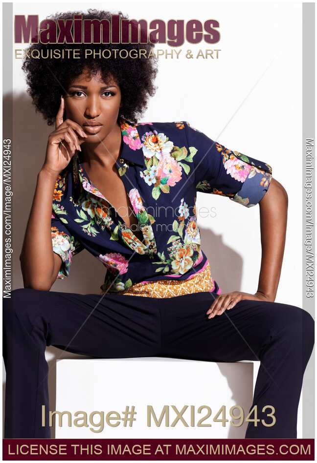 Fashion photo of young black woman in dark floral shirt