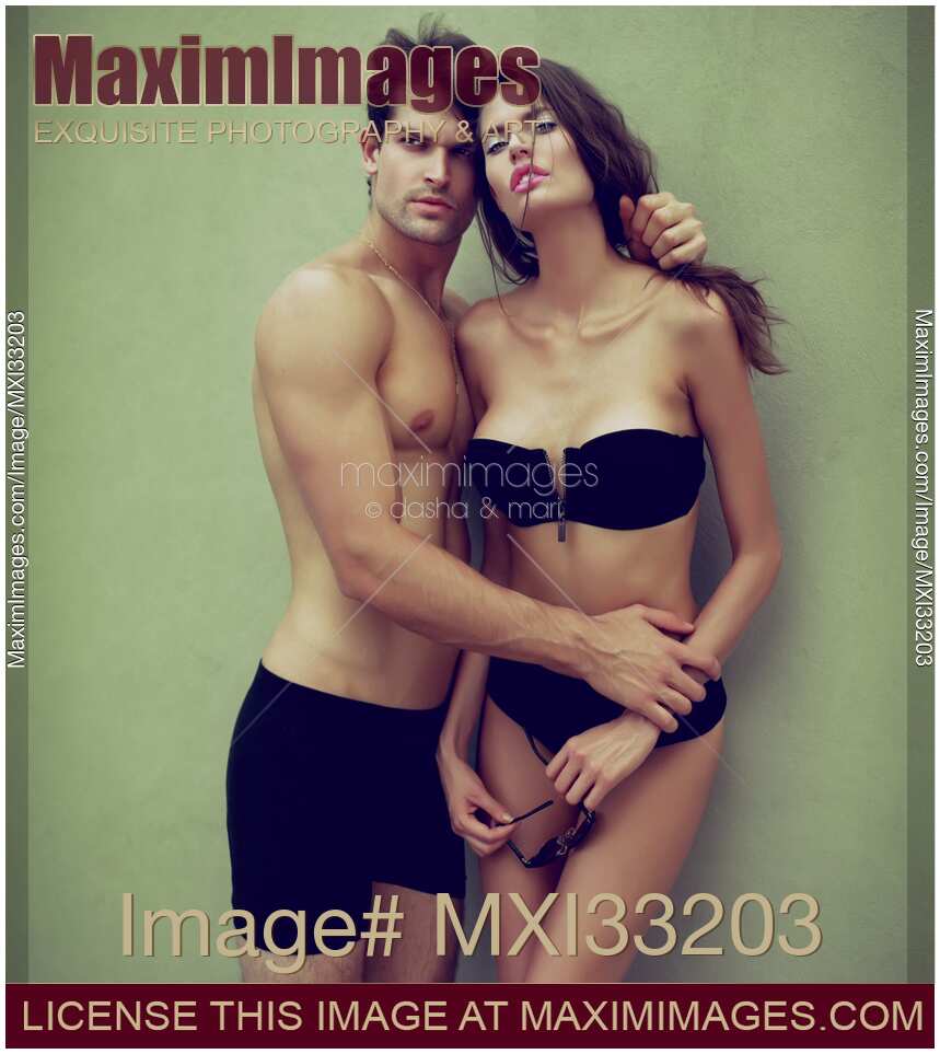 Fashion portrait of a sexy young couple in black underwear