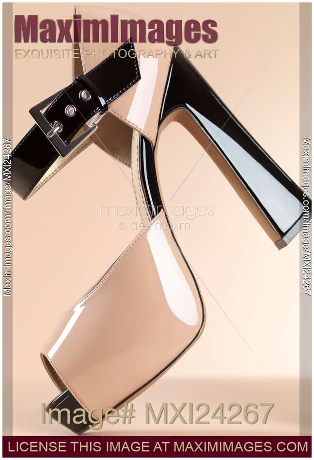 Fashionable high heel shoe on beige