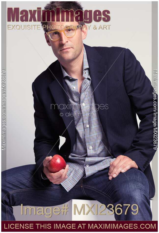 Fashionably Dressed Man with an Apple in Hand
