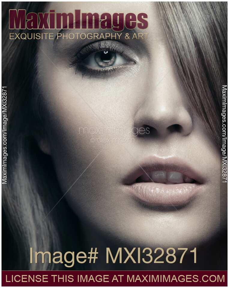 Femme fatale beautiful mysterious woman face with strong sensual look and bangs covering her eye