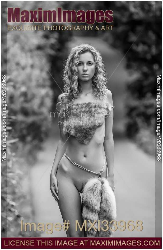 Fine art nude black and white portrait of a half-naked woman in wild fur clothes