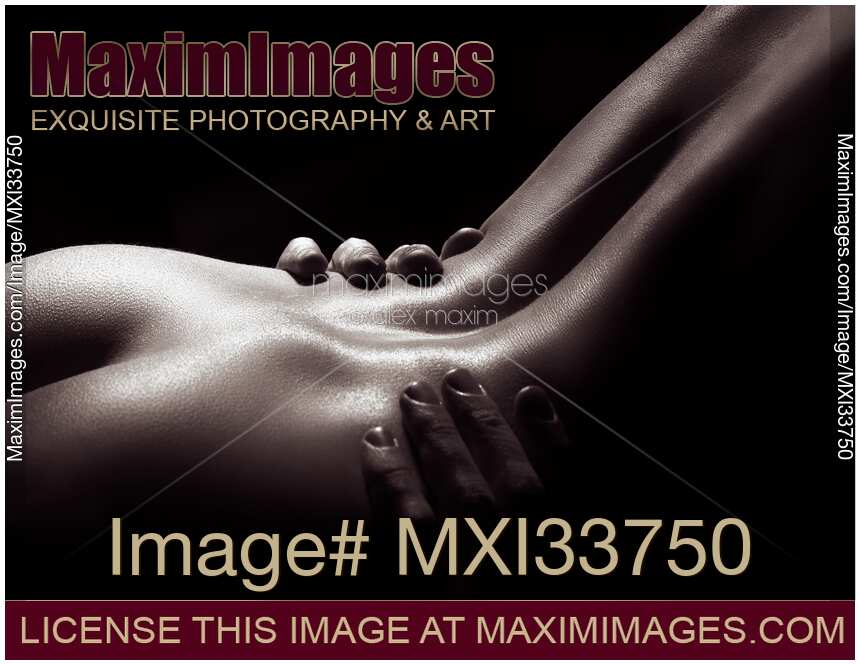 Fine art nude body parts photograph of naked sensual couple making love in black and white